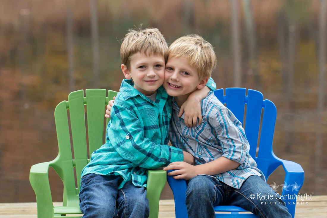 two boys hugging, brothers, green chair, blue chair, Katie Cartwright Photography